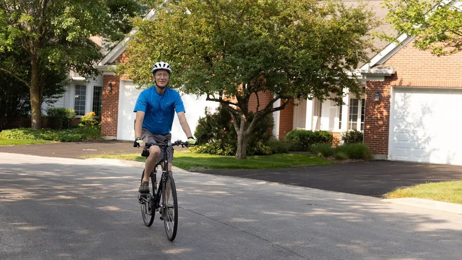 Resident of The Moorings of Arlington Heights wearing a protective helmet while riding his bike because it's one of the 10 ways to prevent Alzheimer's at Arlington, IL.