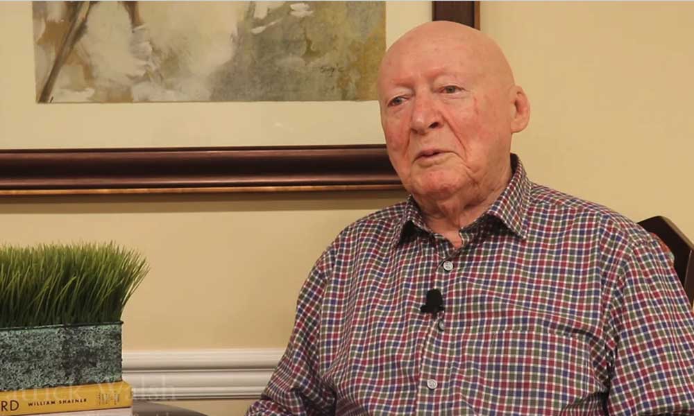 a screenshot of a video of a resident talking about why he loves living at his senior living community