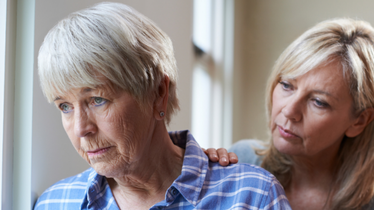 memory-loss-and-dementia-750×422 (1) (1) an adult daughter affectionately putting her hand on her mother's shoulder
