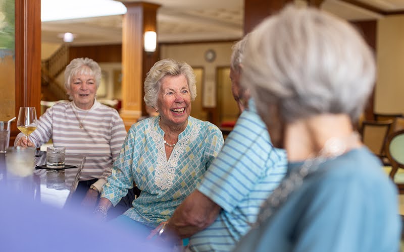 Group of residents enjoying a cocktail together at Lake Forest Place