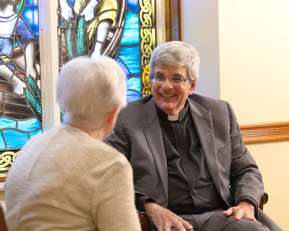 Chaplain speaking with a resident in the chapel at Lake Forest Place