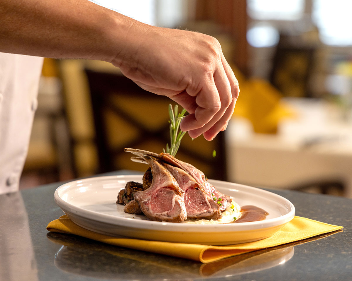 Chef preparing a delicious rack of lamb at Lake Forest Place