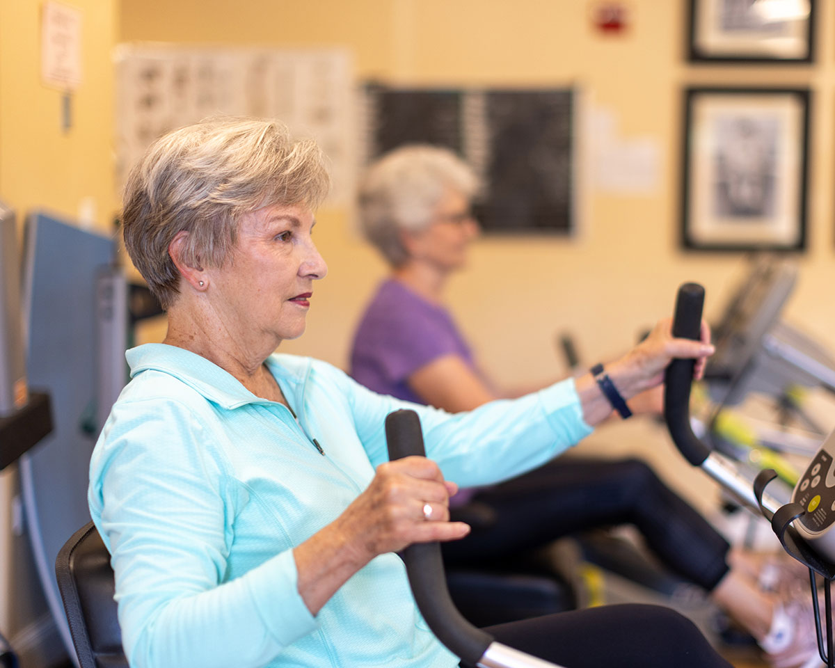Resident woman working out in the Fitness Center at Lake Forest Place