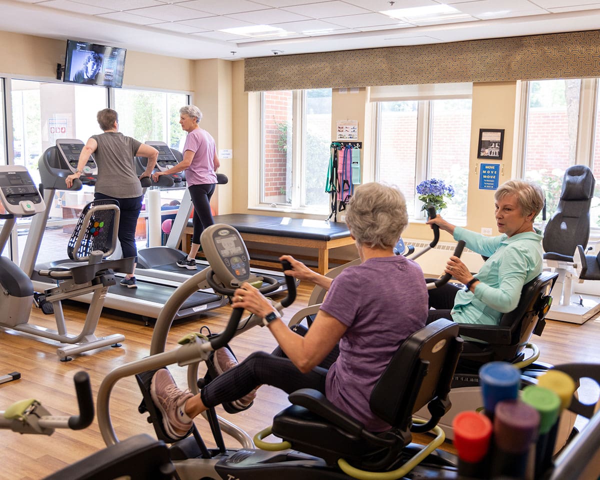 Residents working out in the Fitness Center at Lake Forest Place