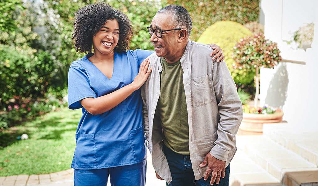 Skilled Nursing patient at Lake Forest Place enjoying a walk outdoors with his caregiver Skilled Nursing patient at Lake Forest Place enjoying a walk outdoors with his caregiver