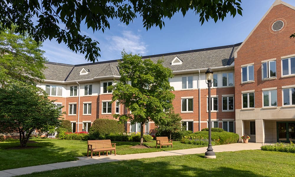Beautiful shot of the campus at Lake Forest Place with a walking path and benches