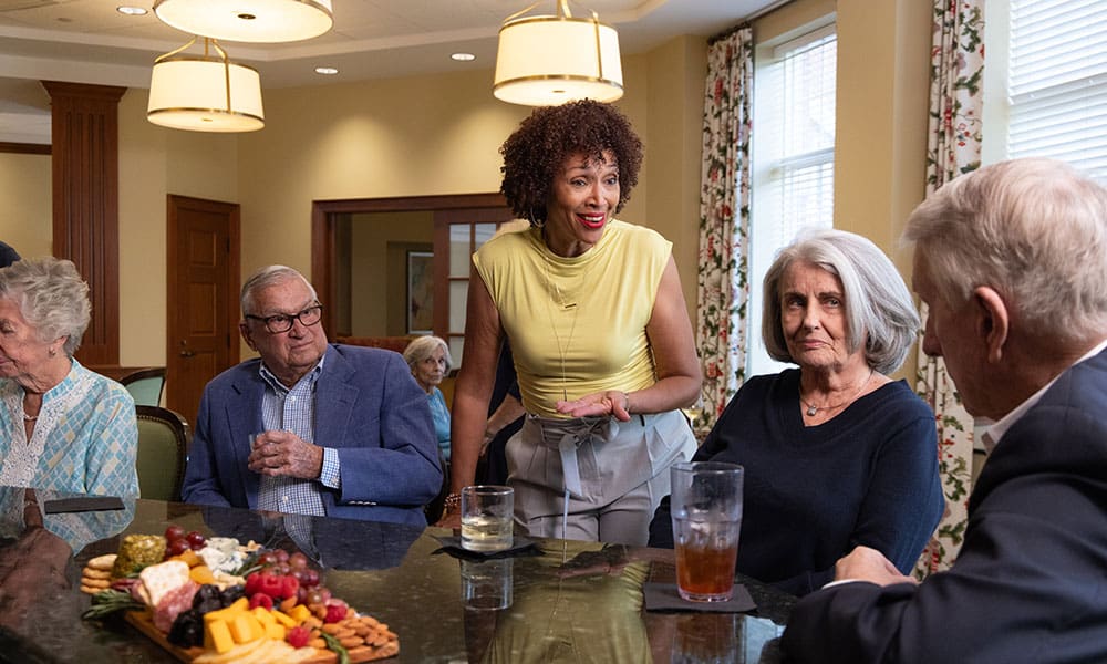 Residents enjoying a meal together in the dining room at Lake Forest Place