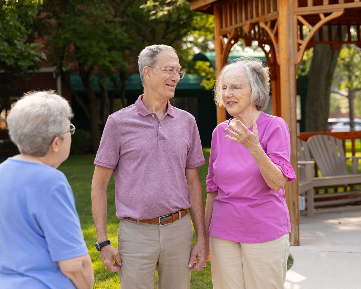 Residents chatting near a gazebo at The Moorings of Arlington Heights