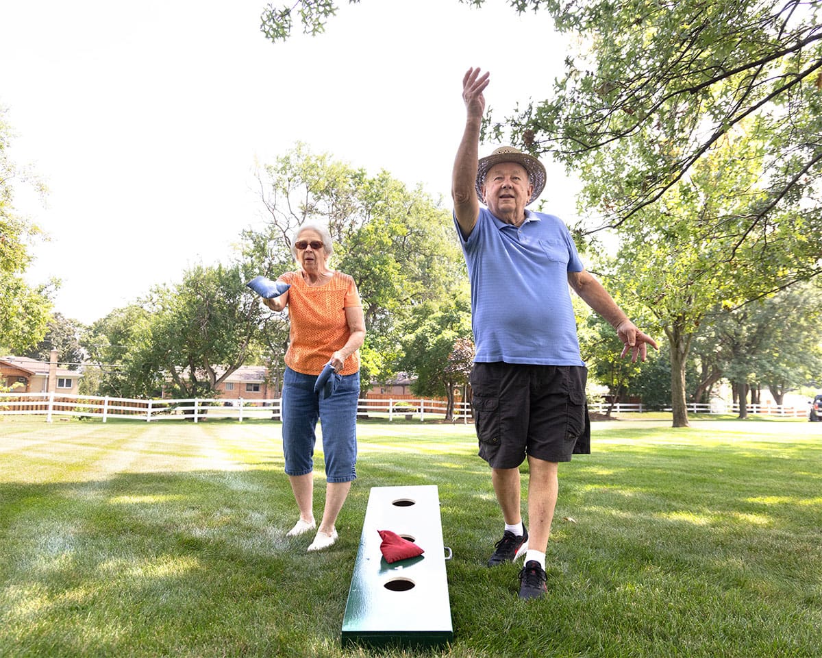Residents playing cornhole at The Moorings of Arlington Heights