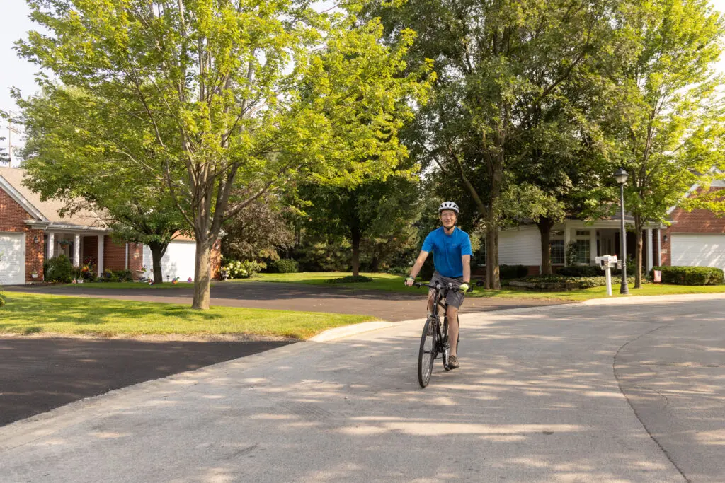 Senior riding bike at The Moorings of Arlington Heights