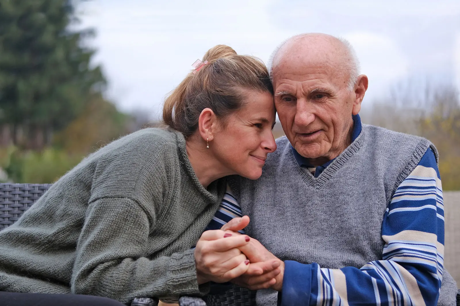PHLF-August-Blog-Featured-Image Senior man sitting on a bench outdoors with his caregiver
