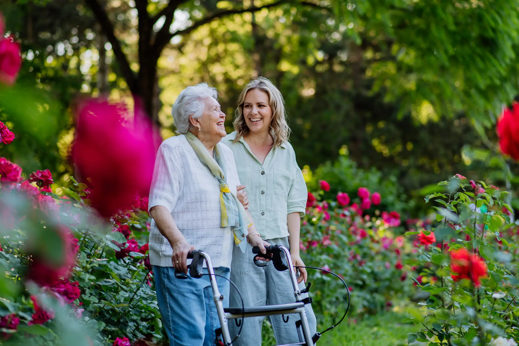 A senior woman walking through a garden with her daughter at Presbyterian Living in Lake Forest, an Assisted Living community.