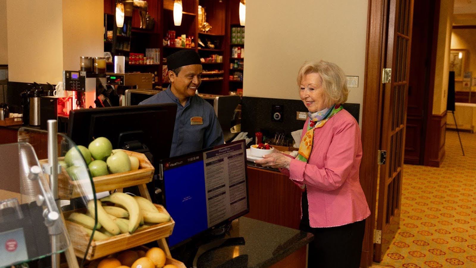 PHLF March 2024 Blog Featured Image Resident of Lake Forest Place choosing a healthy snack at the bistro