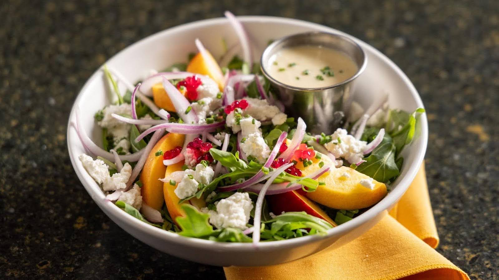 A healthy salad containing fresh fruits and vegetables