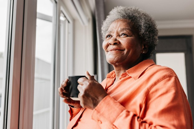 PHMA 70618 SEO Blog Refresh_ Hidden Costs of Aging in Place a senior woman enjoying a cup of coffee as she looks out the window