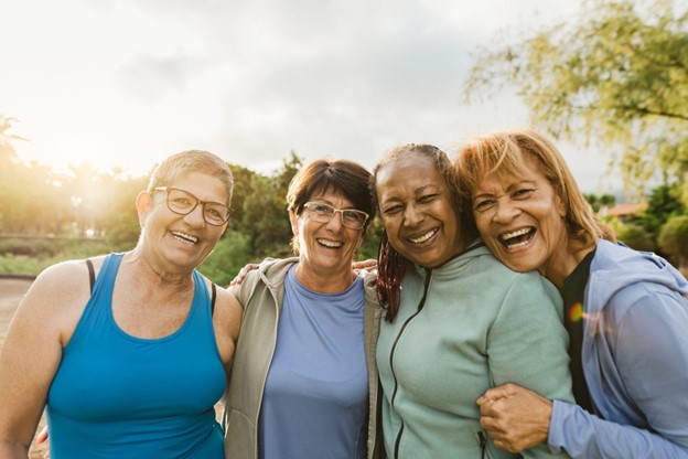 PHMA 70618 SEO Blog Update_ Staying Healthy as You Age a group of senior women in fitness clothing laughing together outside as the sun sets