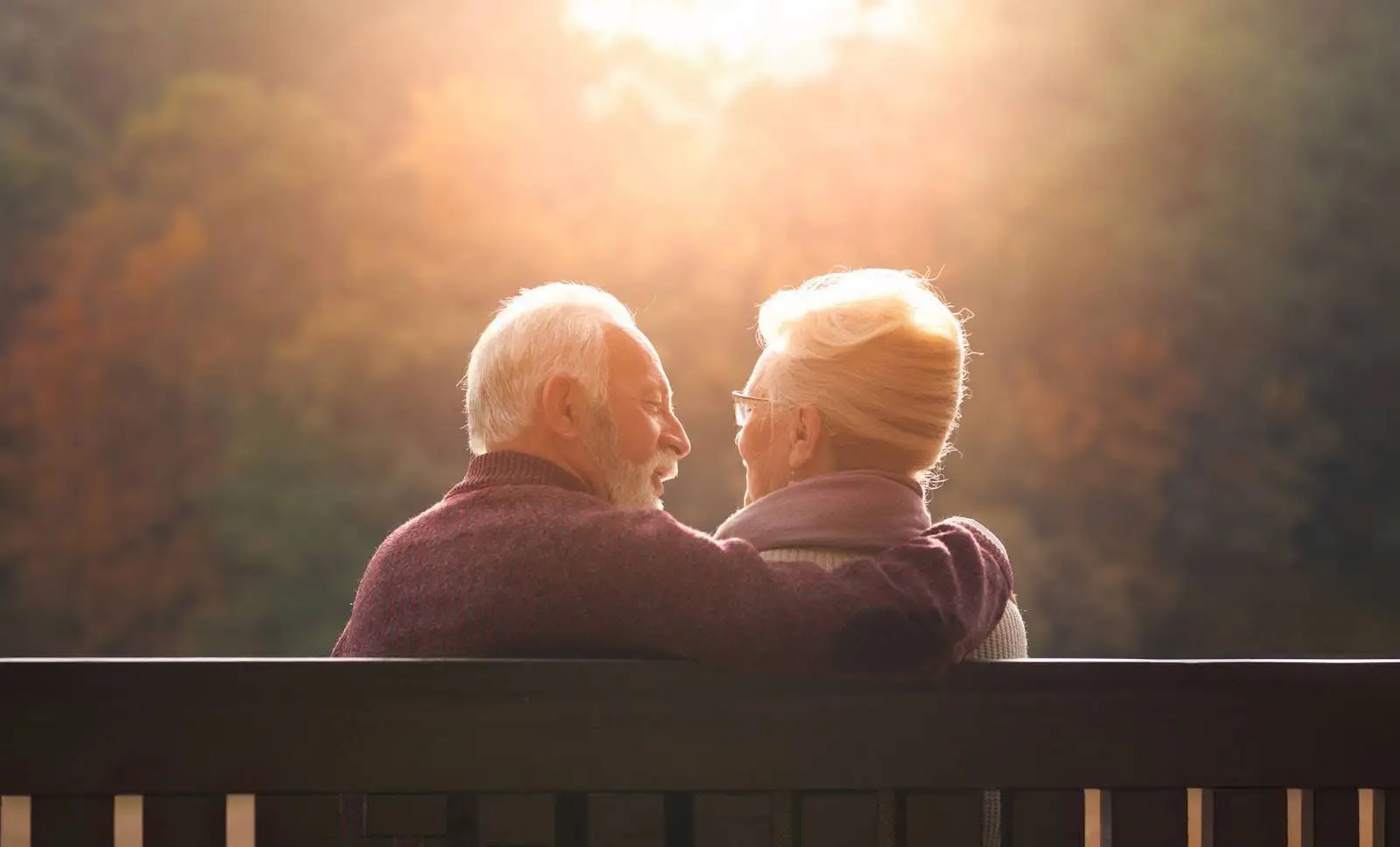 PHMA-January-Blog-Featured-Image Senior couple on a park bench watching the sunset together