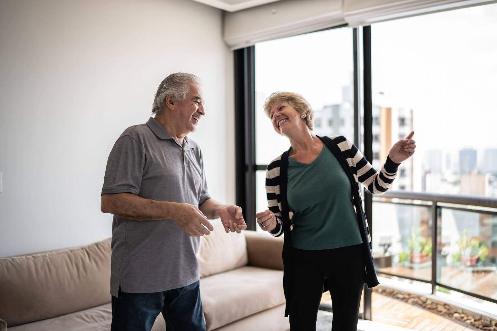 Senior couple dancing in their apartment at Ten Twenty Grove