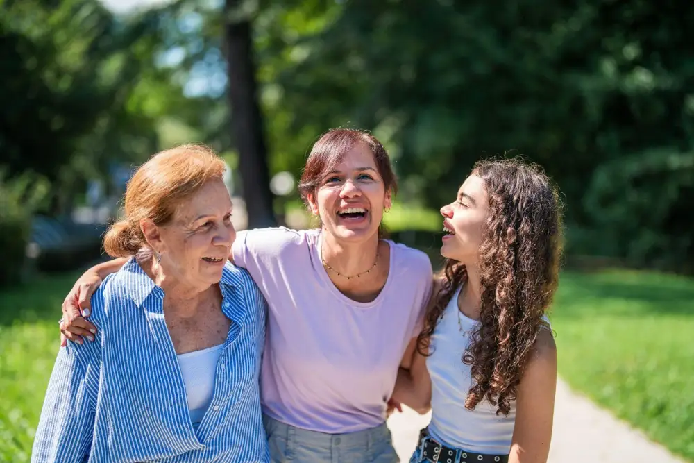 a senior woman outside with her daughter and granddaughter