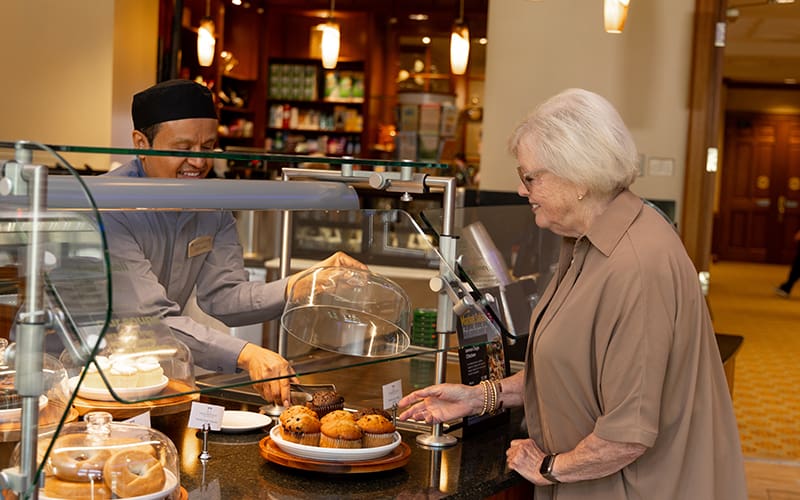 Senior woman deciding what to eat at the bistro at Lake Forest Place
