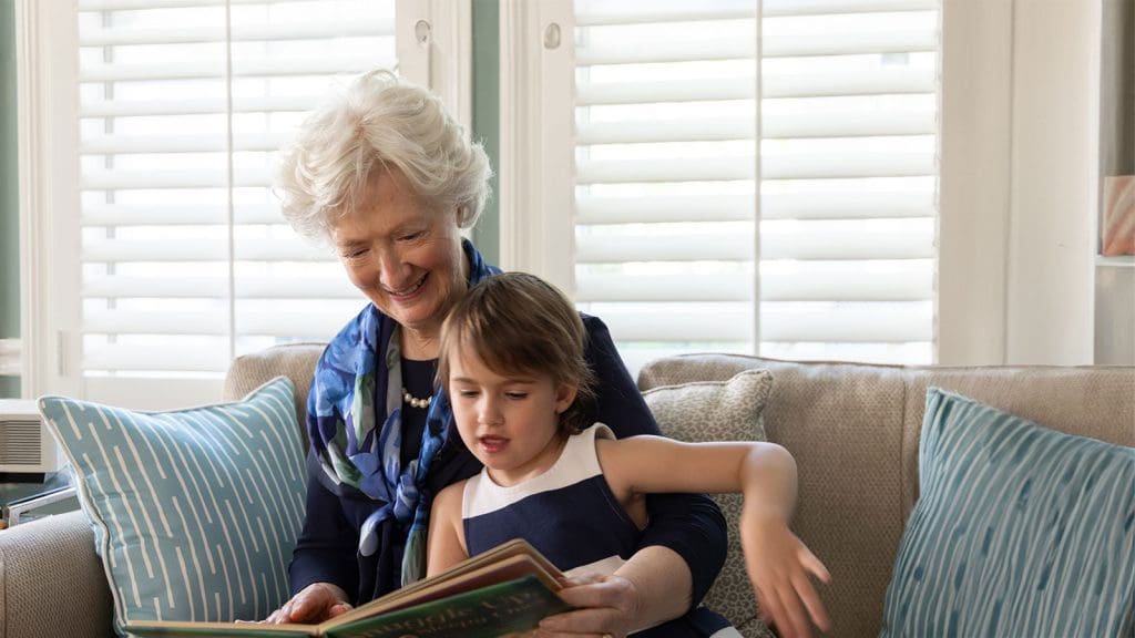 Resident reading a book with her granddaughter at Lake Forest Place, an Independent Living community. How much does independent living cost? Resident reading a book with her granddaughter at Lake Forest Place, an Independent Living community. How much does independent living cost?
