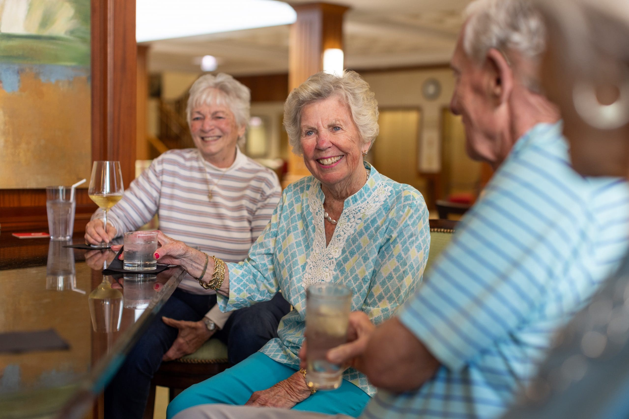A group of seniors sharing a drinks at Club 1904, a VIP plan at Lake Forest Place in IL.