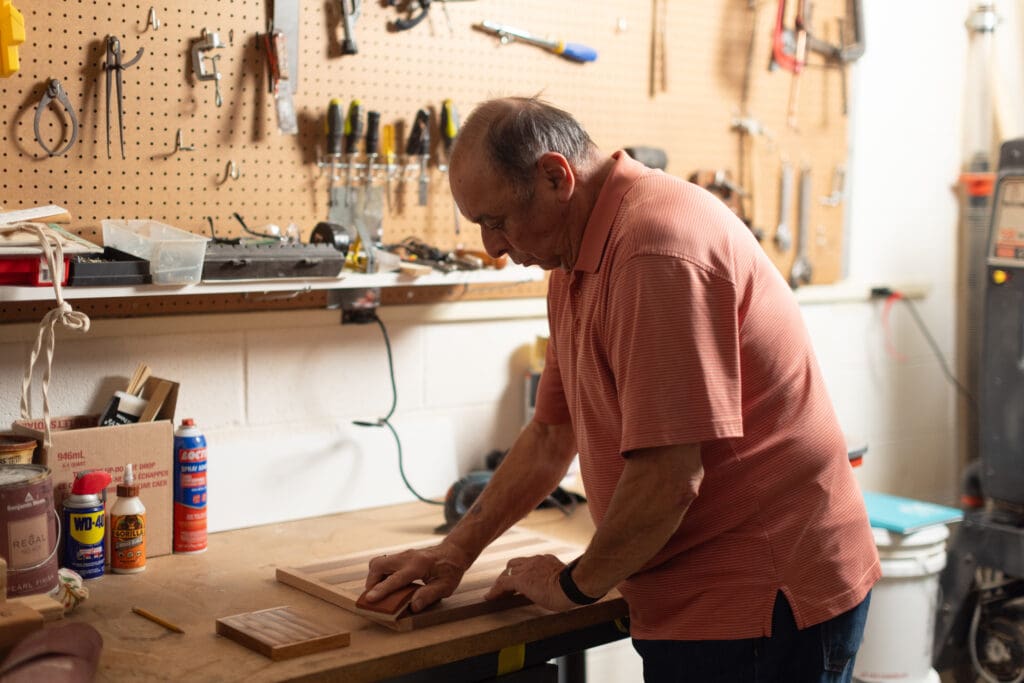 senior man doing woodworking