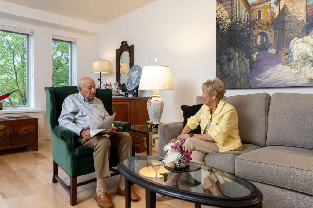 seniors talking in living room at Lake Forest Place