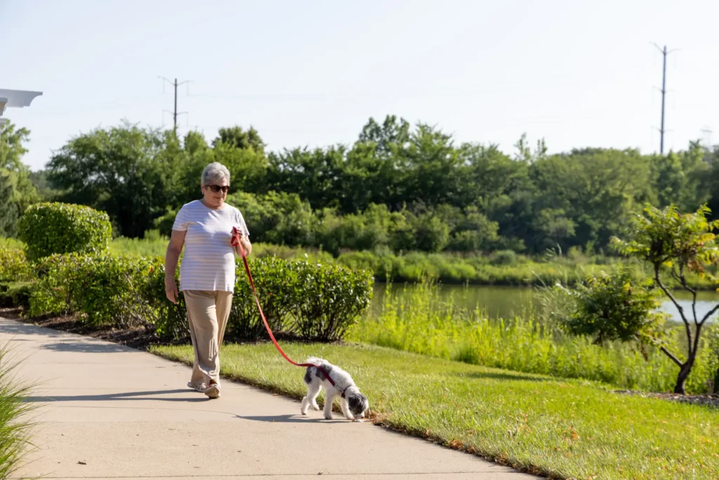 senior woman walking dog at Lake Forest Place