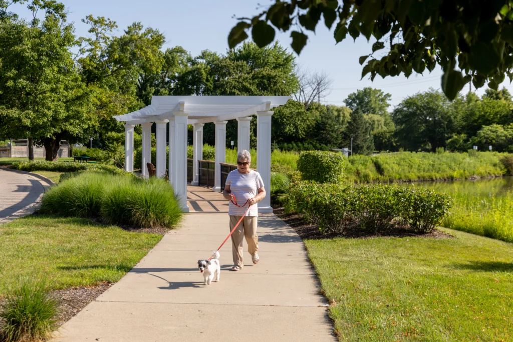 senior woman walking dog at Lake Forest Place
