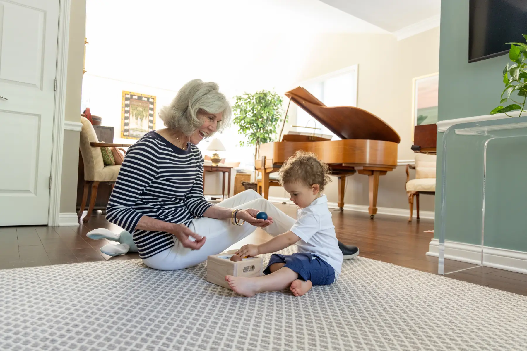 VR5_4381 senior woman playing on the floor with her toddler grandson