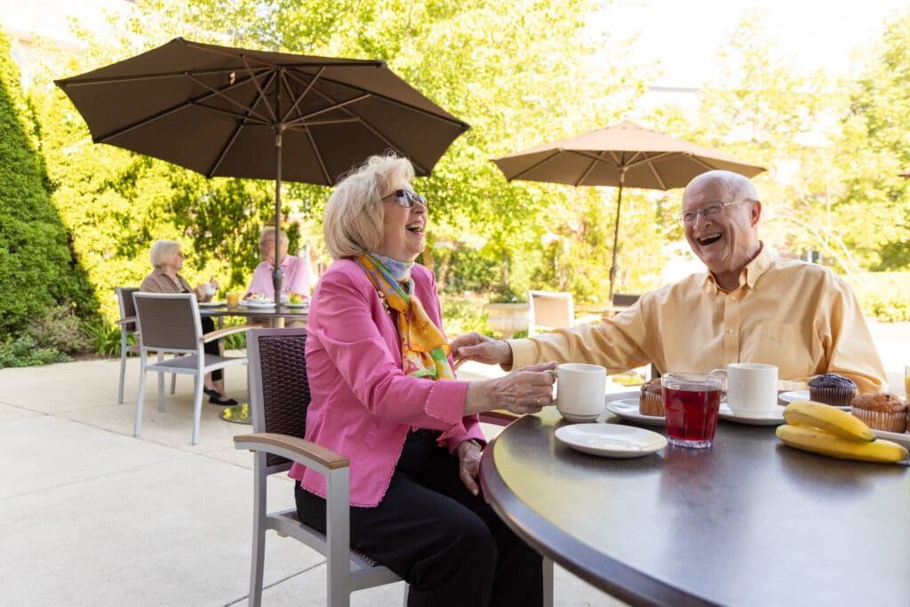 senior couple relaxes and dines outside, enjoying retirement
