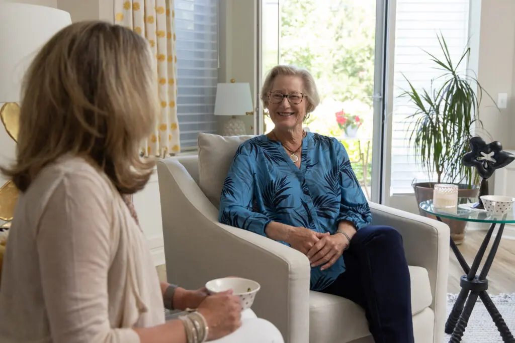 senior smiling and chatting with friend