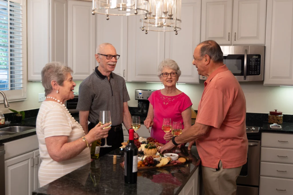 senior couples gathered around kitchen island at Lake Forest Place