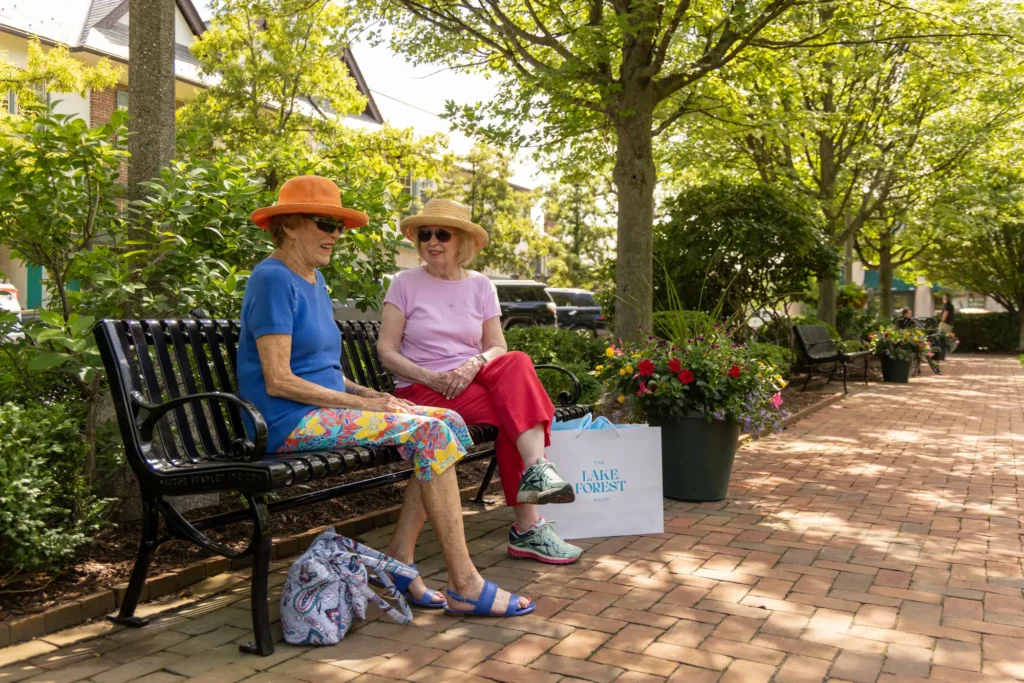 Two senior women sitting on bench at Lake Forest Place
