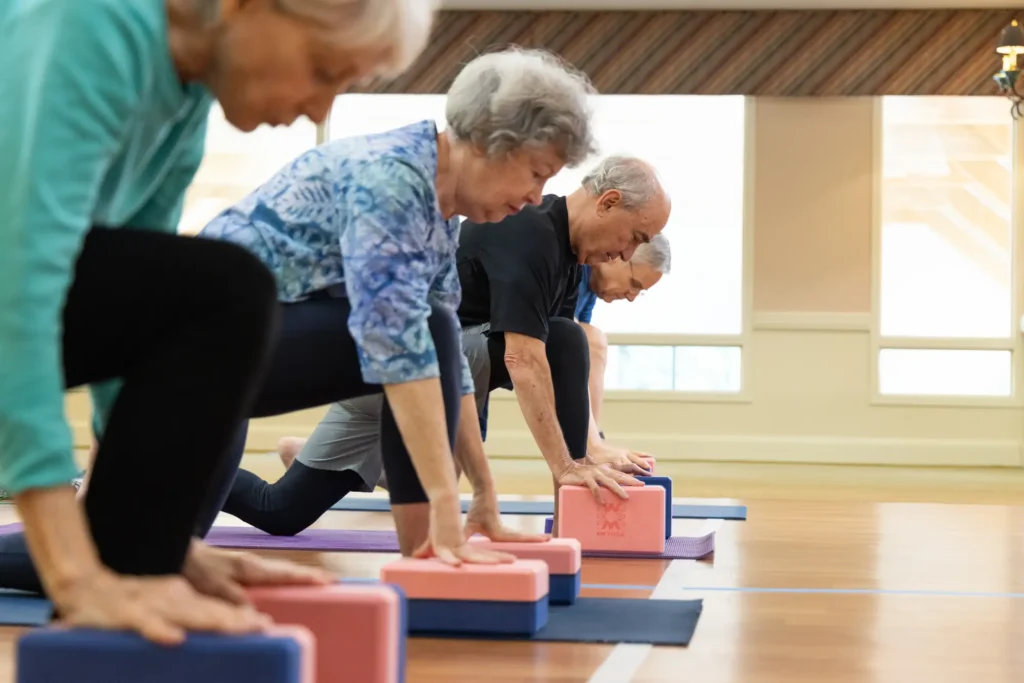 seniors doing yoga with blocks at Westminster Place