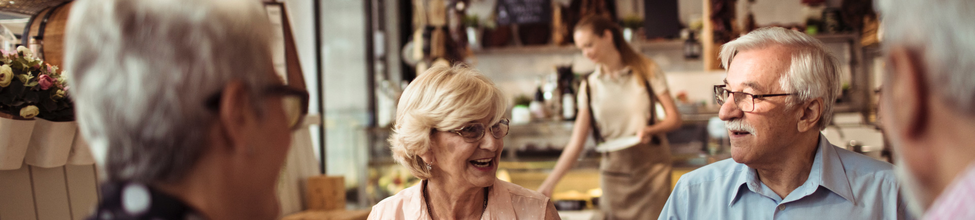 a group of seniors enjoying a meal inside of a restauarant
