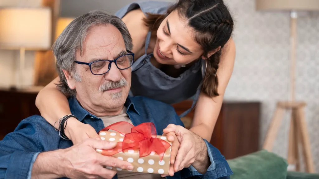 Woman giving senior dad a present