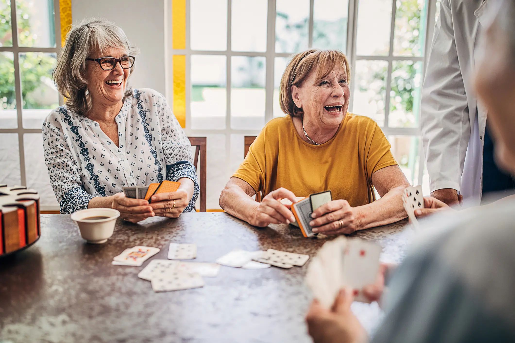seniors playing card game at table