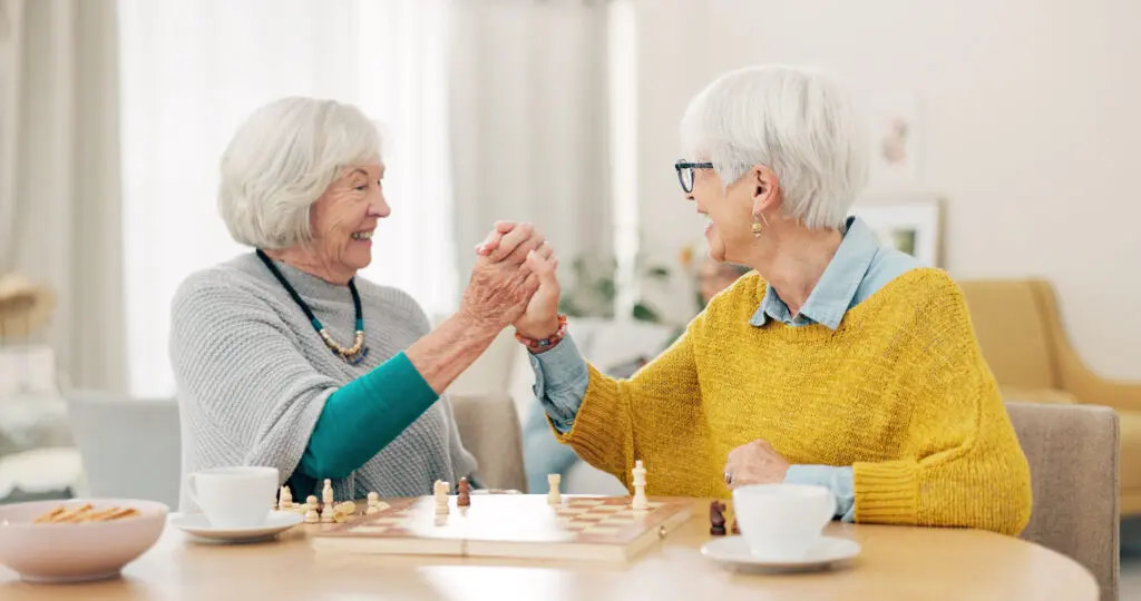 two senior women playing chess