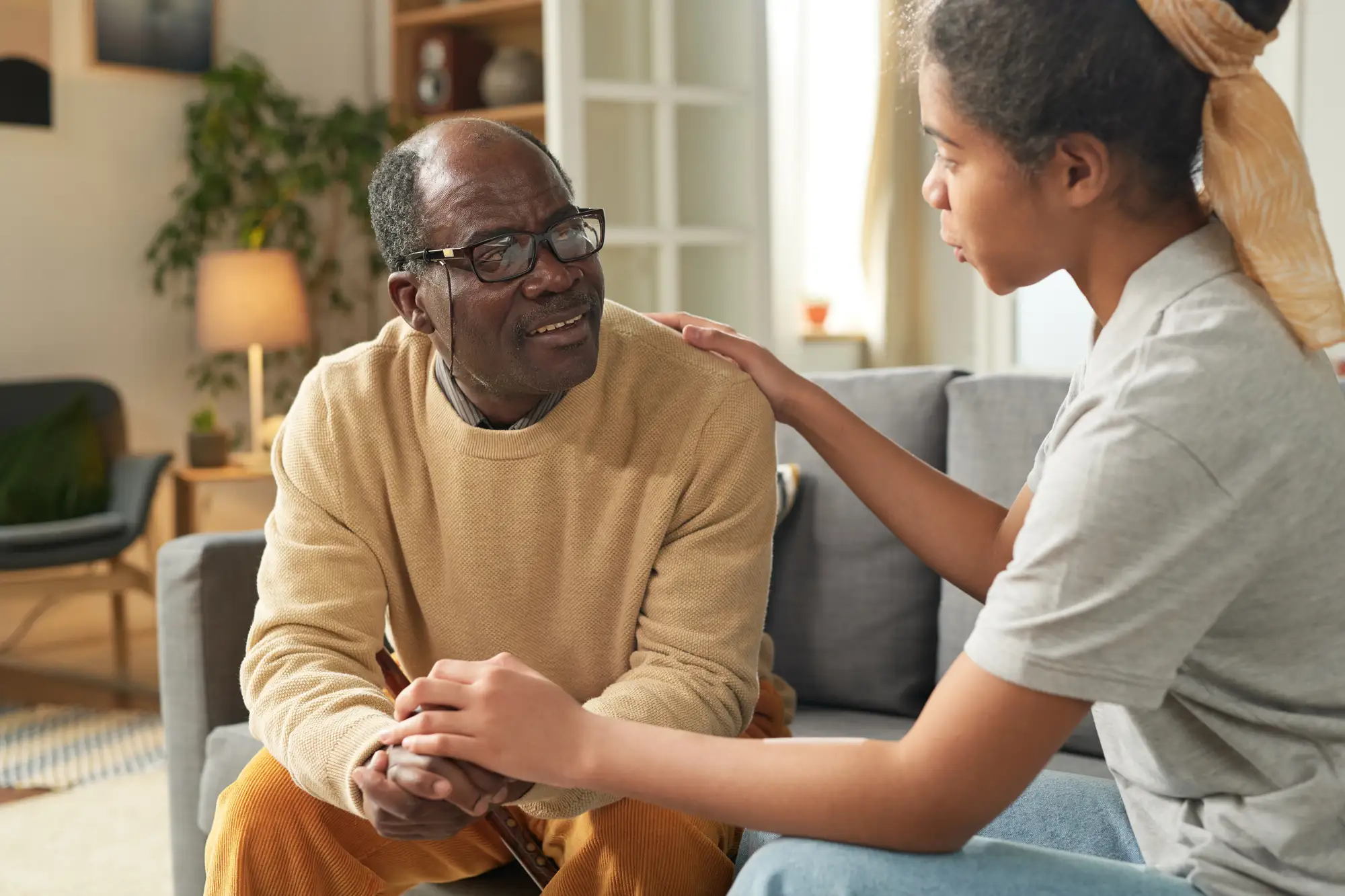senior man and adult daughter in their home at Lake forest Place, while discussing tips on stress relief for seniors.