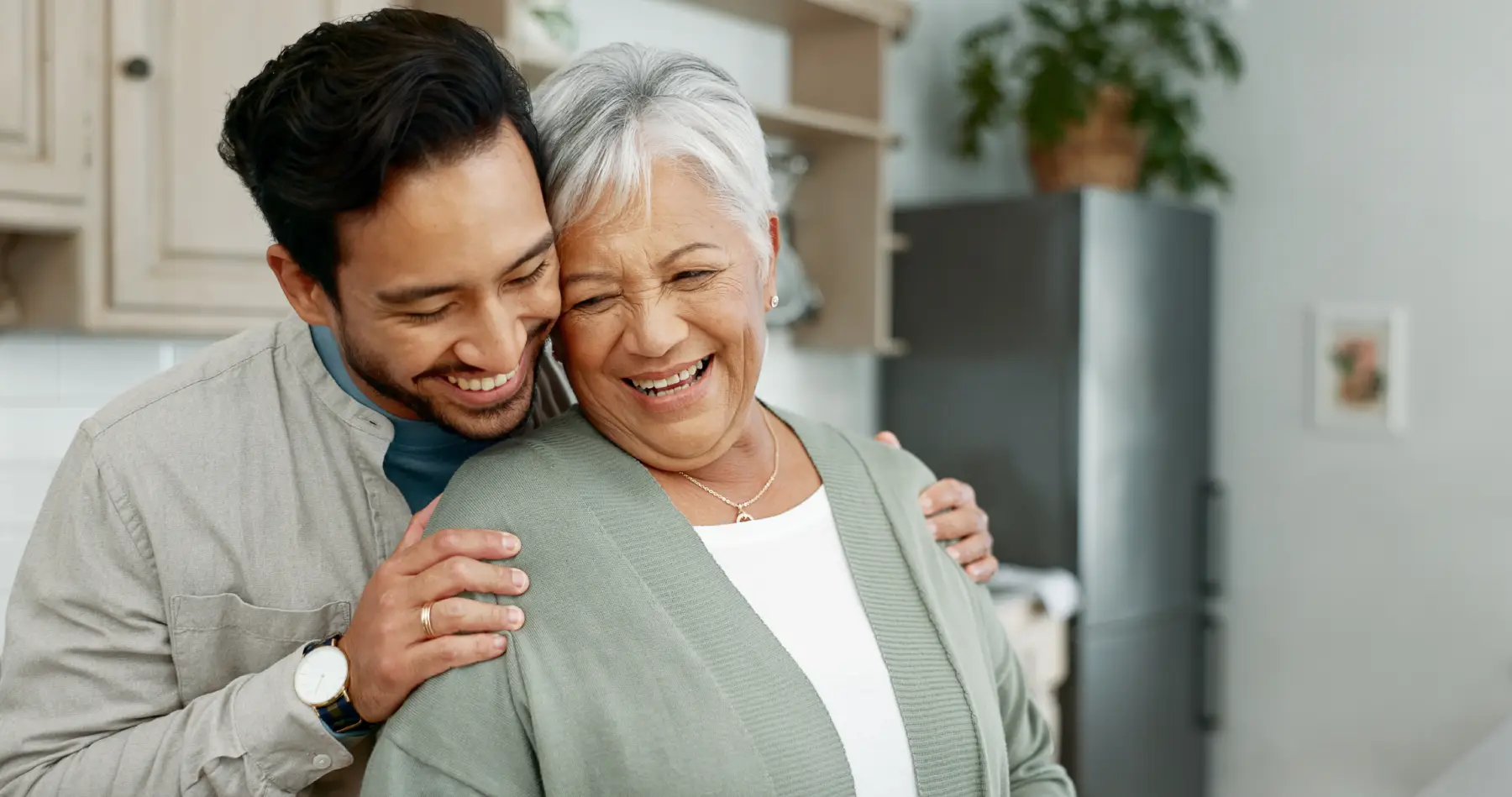 iStock-2172335723 a man hugging his senior mother