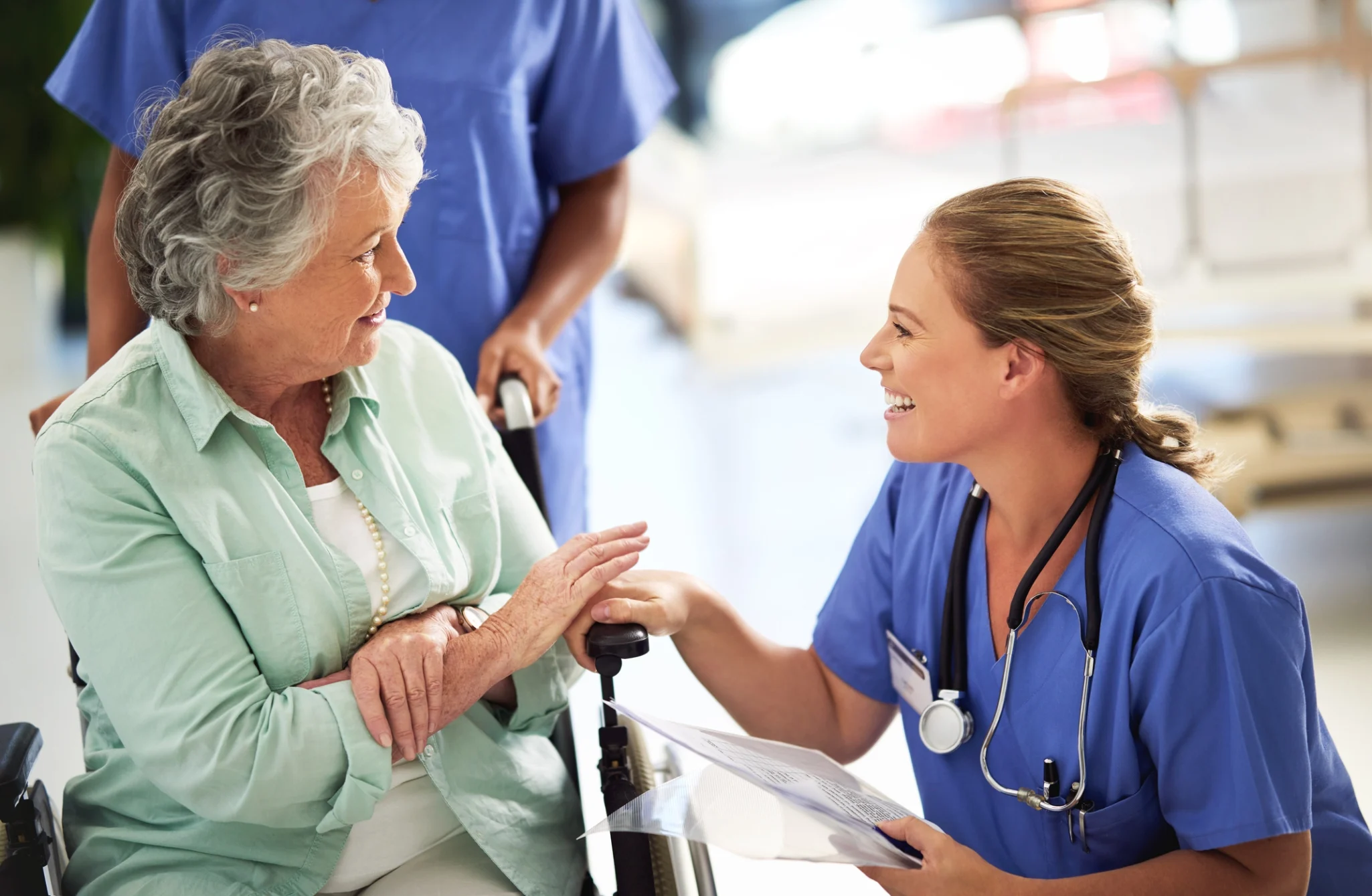 senior woman and nurse helping her