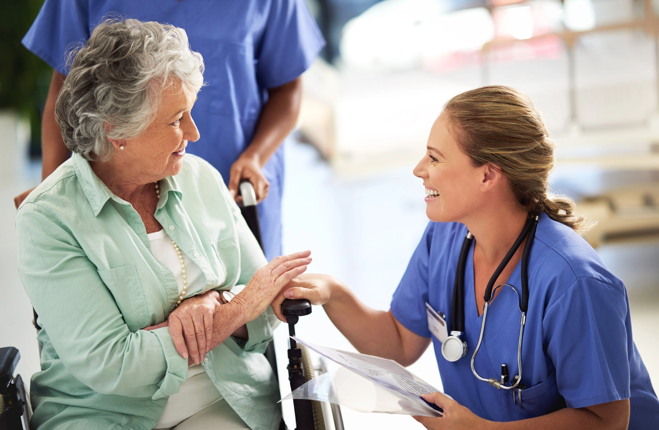 senior woman and nurse helping her