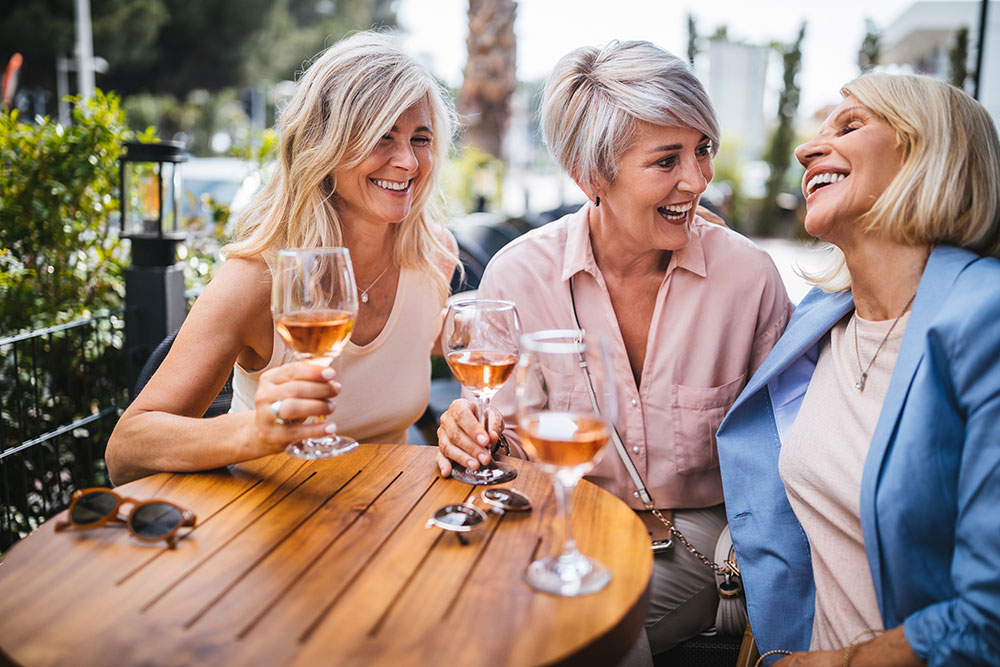 iStock-987828700-opt 3 senior women sipping wine at an outdoor restaurant table