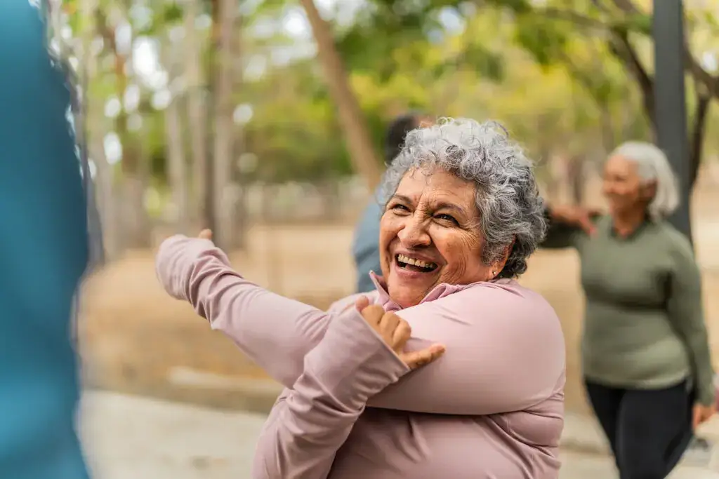 A senior woman stretching. Explore independent living vs. assisted living Lake Forest Place, IL