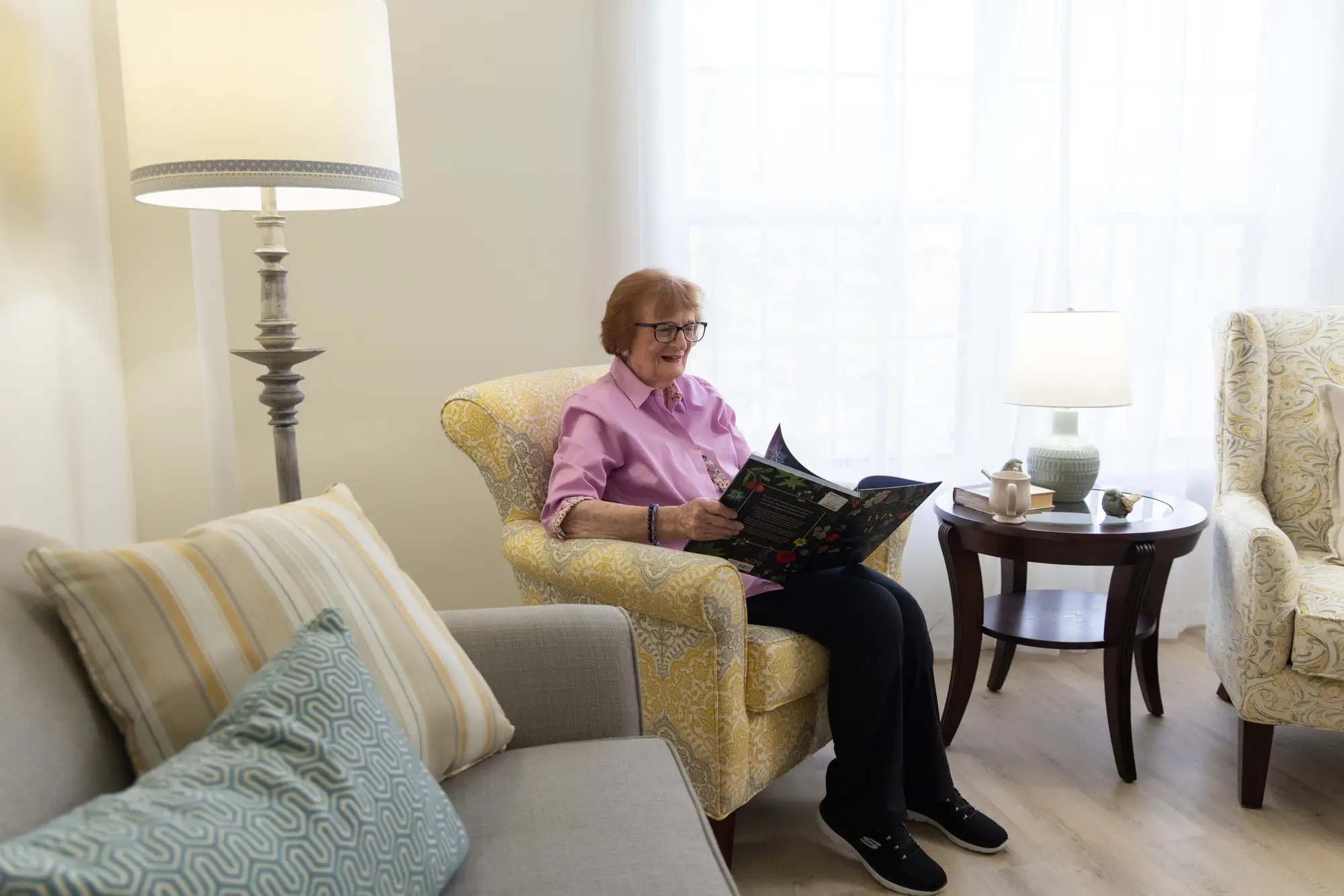 senior woman reading about senior downsizing tips