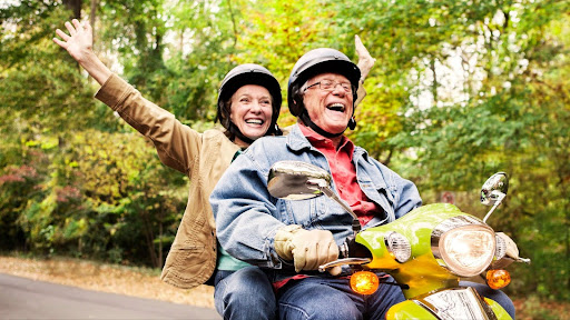 senior couple on moped on nature trail