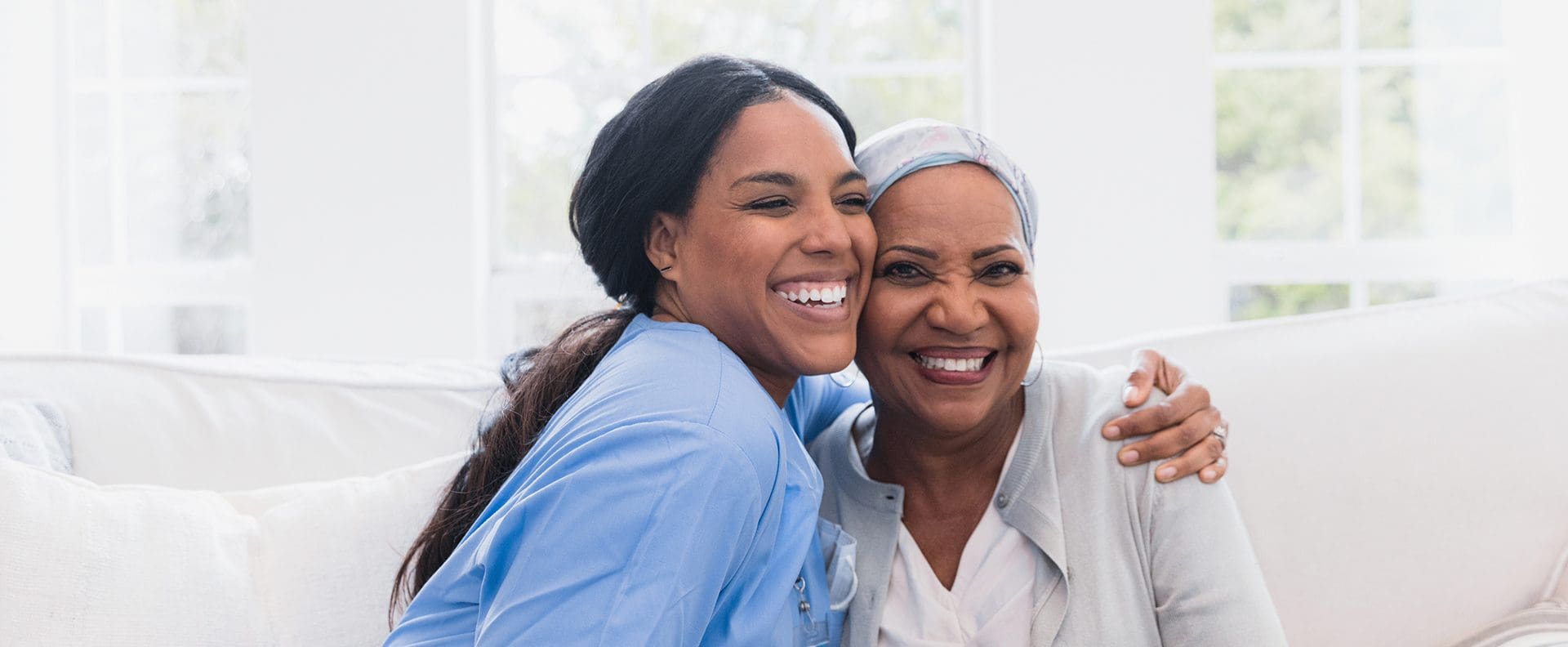 senior woman hugging her caregiver at a CCRC