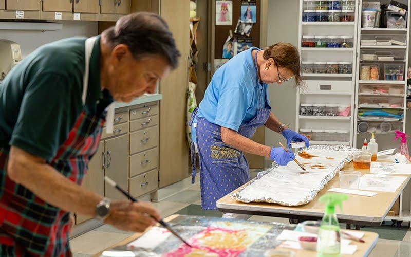 Elderly couple enjoying a painting workshop